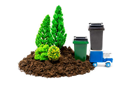 Toy trees and trash containers with a garbage truck isolated on white. Clean forest concept.