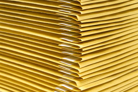 Close-up of a stack of yellow padded envelopesの写真素材