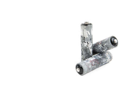 Close-up of three heavily corroded AA batteries isolated on white background, copy space.の写真素材