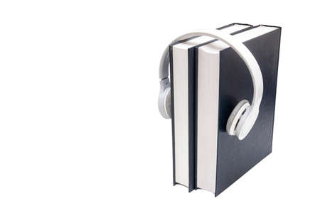Books and wireless headphones isolated on white. Audio book concept.の写真素材