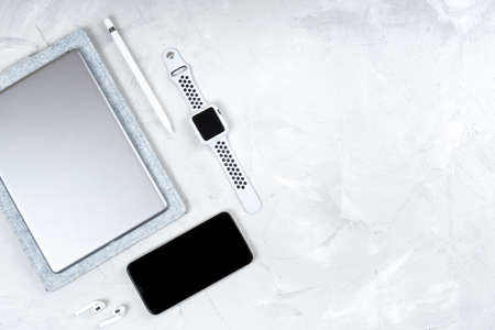 Office productivity gadgets: smartphone, digital tablet, stylus pencil, smartwatch, wireless...
