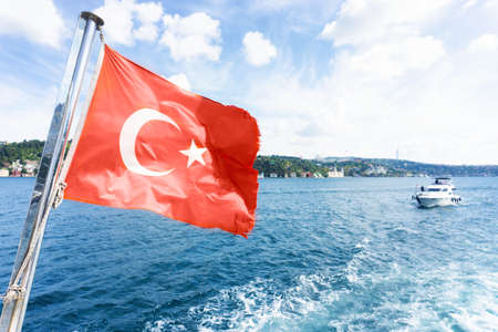 Boat view of the national flag of Turkey and the coastline of Istanbul during the Bosphorus cruiseの写真素材