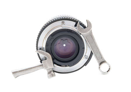 Close-up of a camera lens with a hand tools kit isolated on white. Repair and service concept.の写真素材