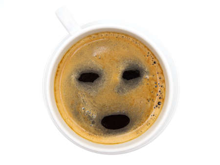 Cup of coffee with a sleepy and tired face. Caffeine helping to stay awake.の写真素材