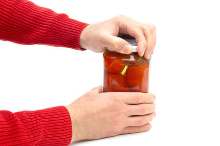 Crop view of male hands opening a jar of pickled tomatoes isolated on white