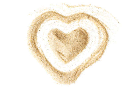 Heart shapes made of sand on a white table backgroundの写真素材