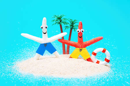 Funny starfish characters posing with a lifebuoy on a toy tropical island. Creative beach vacation...