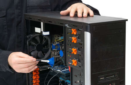 Service center employee wearing black uniform using a brush to dust off internals of a personal...