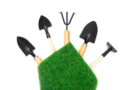 Selection of the essential gardening tools wrapped with a grass patch isolated on white background with copy space.の写真素材