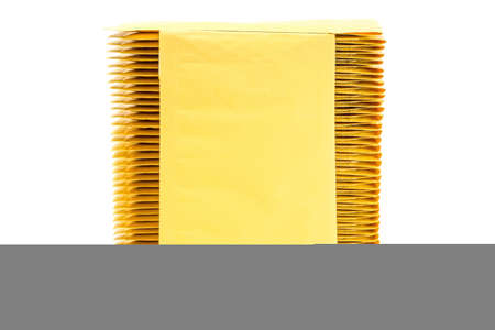 Yellow bubble envelopes isolated on white, product close-up with copy space.の写真素材