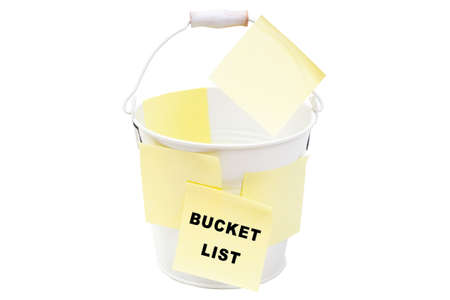 Close-up of a white bucket covered with yellow note stickers reading BUCKET LIST isolated on whiteの写真素材