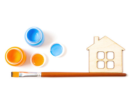 Paint, brush and flat house model isolated on white background. Creative house painting concept.の写真素材