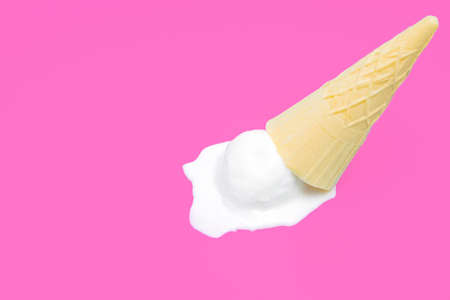 Waffle cone ice cream dropped on a pink background with copy space.の写真素材