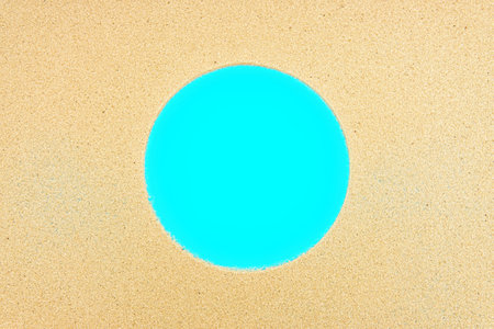 Round frame made from sand on blue. Summer pool vacation background.