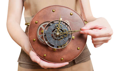 Female holding a circle steampunk leather bag with a clockwork isolated on white.