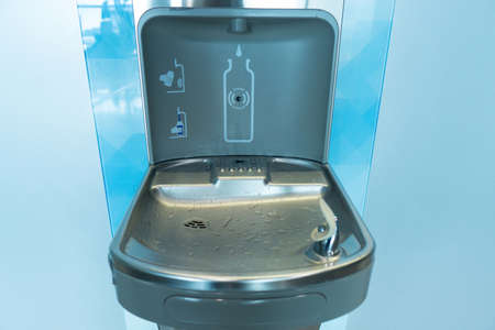 Close-up of a modern drinking fountain and bottle filling station at the airport