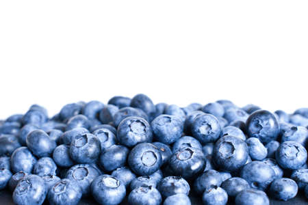 Pile of fresh blueberries against a white background with copy space, selective focus.の写真素材