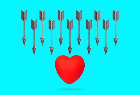 Group of feathered bow arrows attacking a red heart shape isolated on blue background. Heart attack...