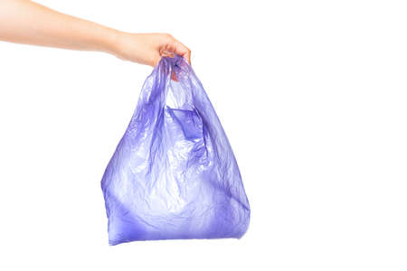 Used purple disposable bag in hand isolated on white backgroundの写真素材
