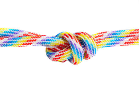 Two multicolored braided cords knotted together isolated on white background. Creative unity...
