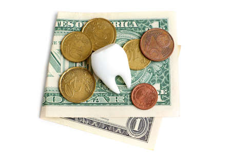 Large white tooth with a one dollar bill and euro coins isolated on white background. Dental...