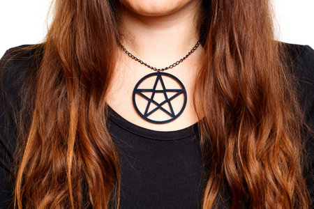 Woman wearing a large black pentagram necklace, close-upの写真素材