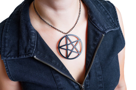 Woman wearing a large black pentagram necklace isolate on white, close-up.の写真素材