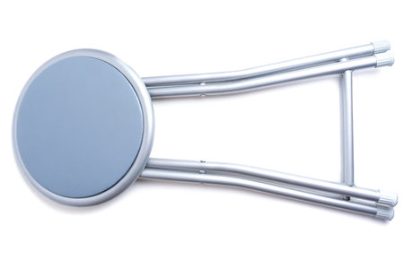 Collapsed padded gray foldable stool isolated on white background.の写真素材