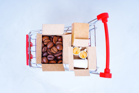 Top view of a push trolley loaded with shipping boxes with roasted coffee beans and espresso cups.の写真素材