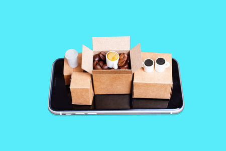 Coffee supplies e-commerce set-up: tiny cardboard boxes with roasted coffee beans and coffee cups...