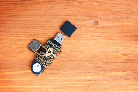 Flash drive wrapped in chains and secured with small keyed padlock. Privacy and data protection...