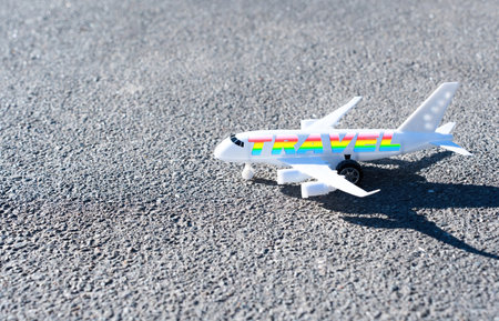 Close-up of a toy aircraft parked on the road. Creative traveling by plane concept.の写真素材
