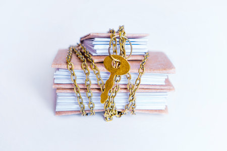 Small accounting ledgers secured with chain and keyed padlock. Protecting business from data loss and bookkeeping fraud.の写真素材