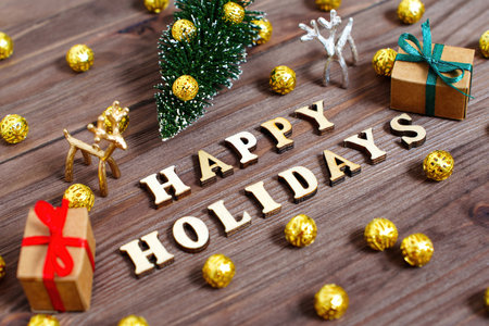 Happy Holidays lettering on a decorated Christmas background.の写真素材