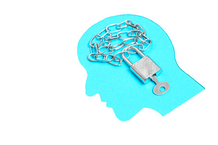 Blue male head profile shape with keyed padlock and chain isolated on white background. Creative mind freezing and locking concept.の写真素材