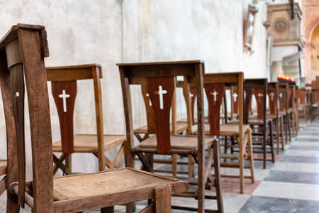 empty wooden chairs in the church during the serviceの写真素材