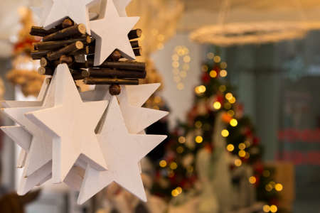 Christmas decoration with stars and Christmas tree in the backgroundの写真素材