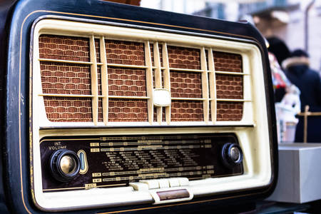 old wooden radio with knobs exposed on the counter of an antique marketの写真素材