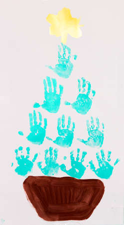 Christmas tree painted with children's handprints in colorful paint.の写真素材