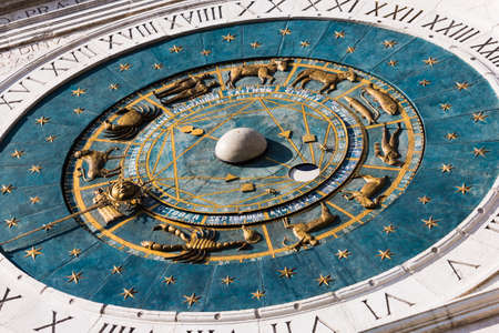 ancient clock with sundial at the top of the tower