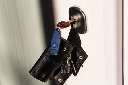 bunch of keys inserted in home door's keyhole