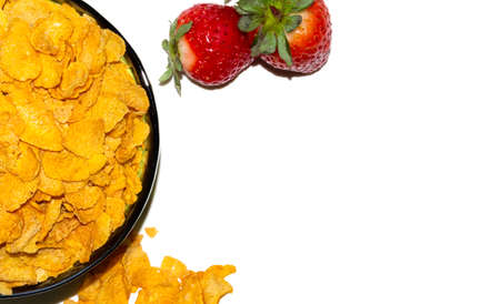 tasty corn flakes and strawberries on a white background.の写真素材