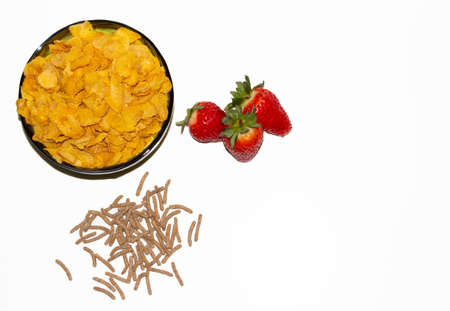 tasty cornflackes, strawberries and bran on a white background.