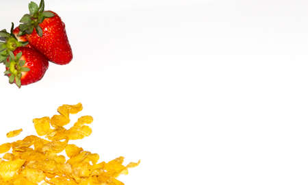 tasty corn flakes and strawberries on a white background.の写真素材