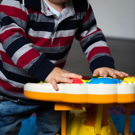 child playing pressing the buttons of his electronic game.の写真素材