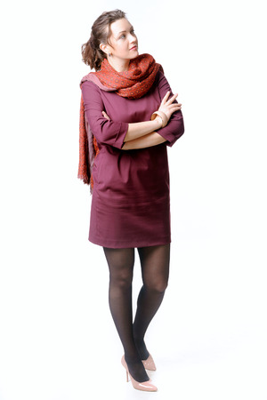 Woman in a burgundy dress with scarf folded her armsの写真素材