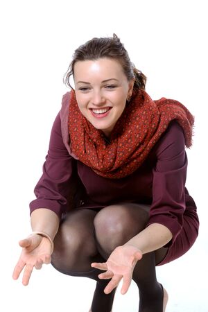 Woman with scarf squatted and laughing to himself invitesの写真素材