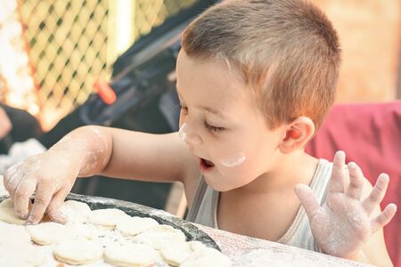 Little cook making dumplingsの写真素材