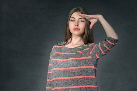 Concept human emotions. Girl shows anxiety against a dark backgroundの写真素材