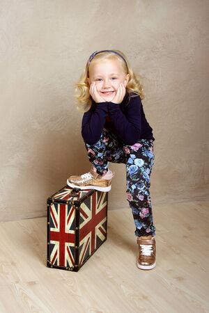 The girl put her foot on suitcaseの写真素材
